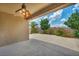 Covered patio provides a comfortable outdoor living space with a ceiling fan and views of the landscaped backyard at 5992 Quintillion Ave, Las Vegas, NV 89122