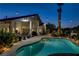 Relaxing backyard with a sparkling pool, string lights, and desert landscaping at 6140 Galileo Dr, Las Vegas, NV 89149