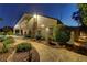 Beautiful backyard with lush landscaping and stone pathway leading to a charming well-lit outdoor space at 6140 Galileo Dr, Las Vegas, NV 89149