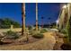 Lush backyard featuring mature landscaping, stone pathways, and palm trees for a serene outdoor retreat at 6140 Galileo Dr, Las Vegas, NV 89149
