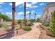 Expansive backyard with meandering flagstone path, lush landscaping, mature palms and views of the pool at 6140 Galileo Dr, Las Vegas, NV 89149
