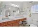 Bright bathroom featuring granite counters, white vessel sink, and decorative wall art at 6140 Galileo Dr, Las Vegas, NV 89149