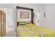 Comfortable bedroom with a bright bedspread, built in alcove and attached bathroom at 6140 Galileo Dr, Las Vegas, NV 89149