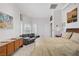 Bright bedroom with a sofa, a dresser, and a window with shutters at 6140 Galileo Dr, Las Vegas, NV 89149