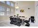 Bright dining room with clerestory windows, modern lighting, and seating for eight at 6140 Galileo Dr, Las Vegas, NV 89149