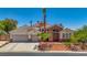 Inviting home featuring stone accents, a three-car garage, and a landscaped front yard with a welcoming entrance at 6140 Galileo Dr, Las Vegas, NV 89149