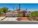 Stunning home boasts desert landscaping, a stone facade, and a three car garage at 6140 Galileo Dr, Las Vegas, NV 89149