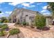 Backyard view of exterior of home with desert landscaping, and flagstone pathway at 6140 Galileo Dr, Las Vegas, NV 89149