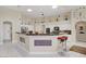 Modern kitchen with white cabinets, a large island with seating, and stainless steel appliances at 6140 Galileo Dr, Las Vegas, NV 89149