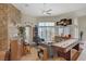 Bright living room featuring a stone fireplace, bar area, and large windows at 6140 Galileo Dr, Las Vegas, NV 89149