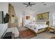 Spacious main bedroom with a stone fireplace, a ceiling fan, and access to the ensuite bathroom at 6140 Galileo Dr, Las Vegas, NV 89149