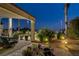 Cozy outdoor seating area with beautiful desert landscaping and ambient string lights at 6140 Galileo Dr, Las Vegas, NV 89149