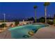 Inviting outdoor pool area with lush landscaping, string lights and lounge chairs creating a perfect space for relaxation at 6140 Galileo Dr, Las Vegas, NV 89149