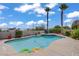 Inviting backyard pool with a sun shelf, lush landscaping, and mature palm trees offering a serene oasis at 6140 Galileo Dr, Las Vegas, NV 89149