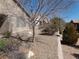 Backyard features low-maintenance desert landscaping and mature trees, creating an inviting space at 6143 Majestic Wind Ave, Las Vegas, NV 89122