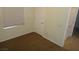 Carpeted bedroom with window and interior door, illustrating the functional space at 6143 Majestic Wind Ave, Las Vegas, NV 89122