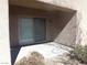 Covered outdoor patio area with a sliding glass door and low-maintenance landscaping at 6143 Majestic Wind Ave, Las Vegas, NV 89122