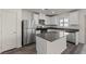 Modern kitchen with stainless steel appliances, a central island, and sleek countertops at 6185 Blood Lily Ave, Las Vegas, NV 89122