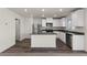 Modern kitchen featuring stainless steel appliances, dark countertops, and a kitchen island at 6197 Blood Lily Ave, Las Vegas, NV 89122