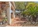 Backyard features a covered patio with tiled flooring, desert landscaping, and a cozy fire pit at 6405 Break Point Ave, Las Vegas, NV 89130