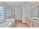 Bright bathroom with a bathtub, a shower, and dual sinks at 6405 Break Point Ave, Las Vegas, NV 89130