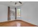 Bright bedroom featuring dual windows, ceiling fan, and stained concrete floors at 6405 Break Point Ave, Las Vegas, NV 89130