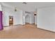 Open living room with tile floors, ceiling fan, and view of kitchen and stairs at 6405 Break Point Ave, Las Vegas, NV 89130