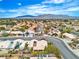 A street view of homes in a well-maintained neighborhood with mature landscaping and varied architectural styles at 6405 Break Point Ave, Las Vegas, NV 89130