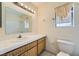 Well-lit bathroom featuring a bright vanity, a large mirror, and a bathtub with tile surround at 6766 Sebring St, Las Vegas, NV 89103