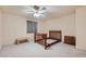 Clean bedroom featuring neutral paint, ceiling fan, and carpeted floor at 6766 Sebring St, Las Vegas, NV 89103