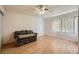 Bedroom featuring wood laminate flooring, a ceiling fan, and a comfortable sofa at 6766 Sebring St, Las Vegas, NV 89103