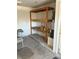 Garage featuring built-in wooden storage shelves and a hot water heater at 6766 Sebring St, Las Vegas, NV 89103