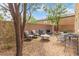 Backyard seating area with gravel, featuring comfortable chairs and tables at 6788 Sharks Bay Ct, Las Vegas, NV 89149