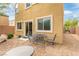 Backyard patio area providing outdoor seating and landscape with a wall for privacy at 6788 Sharks Bay Ct, Las Vegas, NV 89149