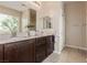 This bathroom features a double sink vanity with granite countertops at 6788 Sharks Bay Ct, Las Vegas, NV 89149