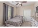 The bedroom features a ceiling fan, closet, and neutral walls and carpeting at 6788 Sharks Bay Ct, Las Vegas, NV 89149