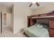 Bedroom with a bunk bed, neutral walls, and a view of the hallway at 6788 Sharks Bay Ct, Las Vegas, NV 89149