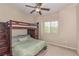 Cozy bedroom featuring a bunk bed with a ceiling fan and window view at 6788 Sharks Bay Ct, Las Vegas, NV 89149