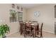 Cozy dining area featuring a wood table and chairs, with natural light and a view to the backyard at 6788 Sharks Bay Ct, Las Vegas, NV 89149