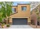 Exterior facade of home with a two-car garage, front yard and desert landscaping at 6788 Sharks Bay Ct, Las Vegas, NV 89149