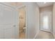 Hallway with tile floors leads to half-bathroom and front door with decorative glass at 6788 Sharks Bay Ct, Las Vegas, NV 89149
