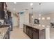 Open concept kitchen with granite countertops, stainless steel appliances, and seamless access to the living area at 6788 Sharks Bay Ct, Las Vegas, NV 89149