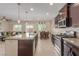Modern kitchen with granite countertops, stainless steel appliances, and an island with bar seating at 6788 Sharks Bay Ct, Las Vegas, NV 89149