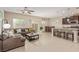 Open concept living room featuring tile floors and a dining area near a kitchen island with bar stool seating at 6788 Sharks Bay Ct, Las Vegas, NV 89149