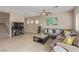 Spacious living room with tile floors, a ceiling fan, a large sectional, and a coffee table at 6788 Sharks Bay Ct, Las Vegas, NV 89149