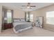 Serene main bedroom with neutral tones, plush carpet, and natural light from multiple windows at 6788 Sharks Bay Ct, Las Vegas, NV 89149