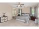 This main bedroom features a ceiling fan and an ensuite bathroom with a soaking tub at 6788 Sharks Bay Ct, Las Vegas, NV 89149