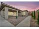 Wide backyard with a covered patio, brick flooring, and well-manicured landscaping at 6865 Steel Mist St, Las Vegas, NV 89148