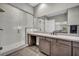 Modern bathroom with a large, glass shower, marble vanity, and dark wood cabinets at 6865 Steel Mist St, Las Vegas, NV 89148