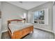 Bedroom featuring a wooden bed frame, window with shutters, and tiled flooring at 6865 Steel Mist St, Las Vegas, NV 89148